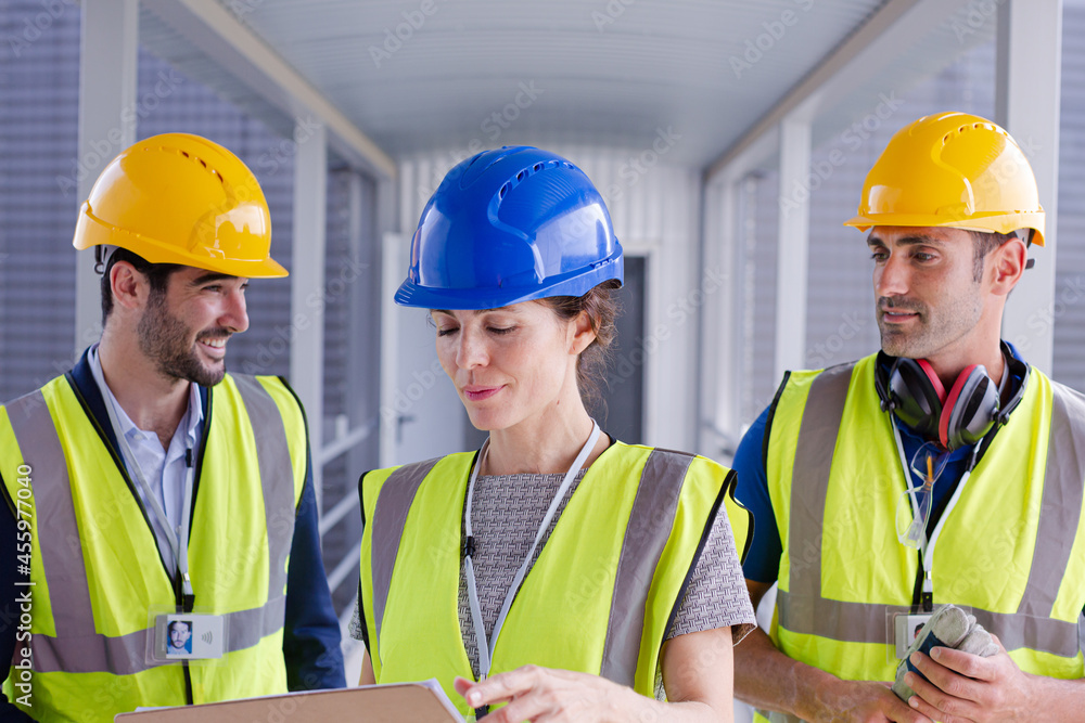 Supervisors and worker with clipboard in factory Supervisors and worker with clipboard in factory