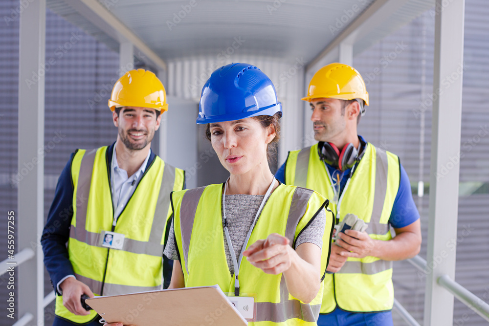 Supervisors and worker with clipboard in factory Supervisors and worker with clipboard in factory