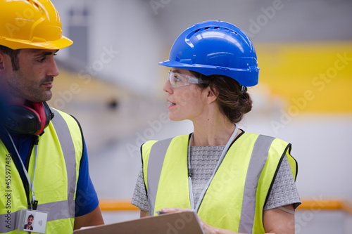 Supervisor and worker talking in factory
