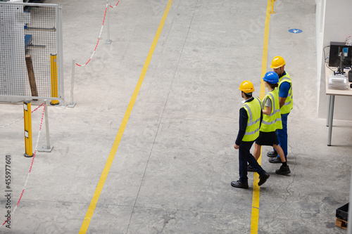 Supervisor and workers walking in factory