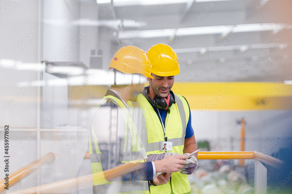 Supervisor and worker talking in steel factory Supervisor and worker talking in steel factory