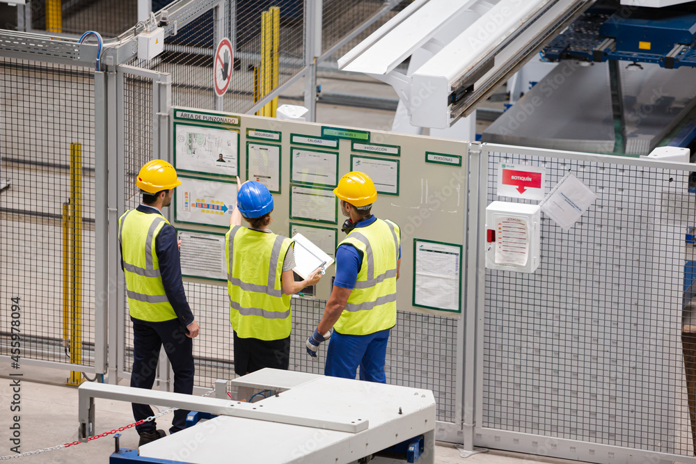 Supervisor and workers talking in factory