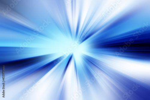 Abstract radial zoom blur surface in dark blue, light blue and white tones. Bright glowing blue background with radial, radiating, converging lines. © kati17