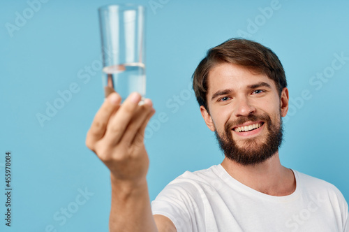 pretty man glass of water blue background