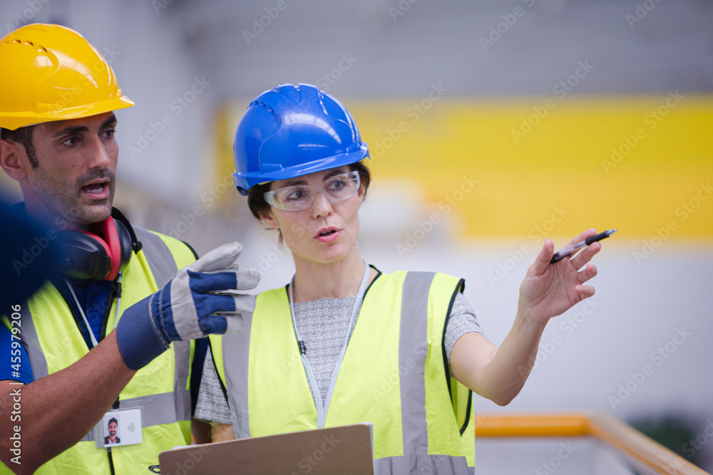 Supervisor and worker talking in factory Supervisor and worker talking in factory