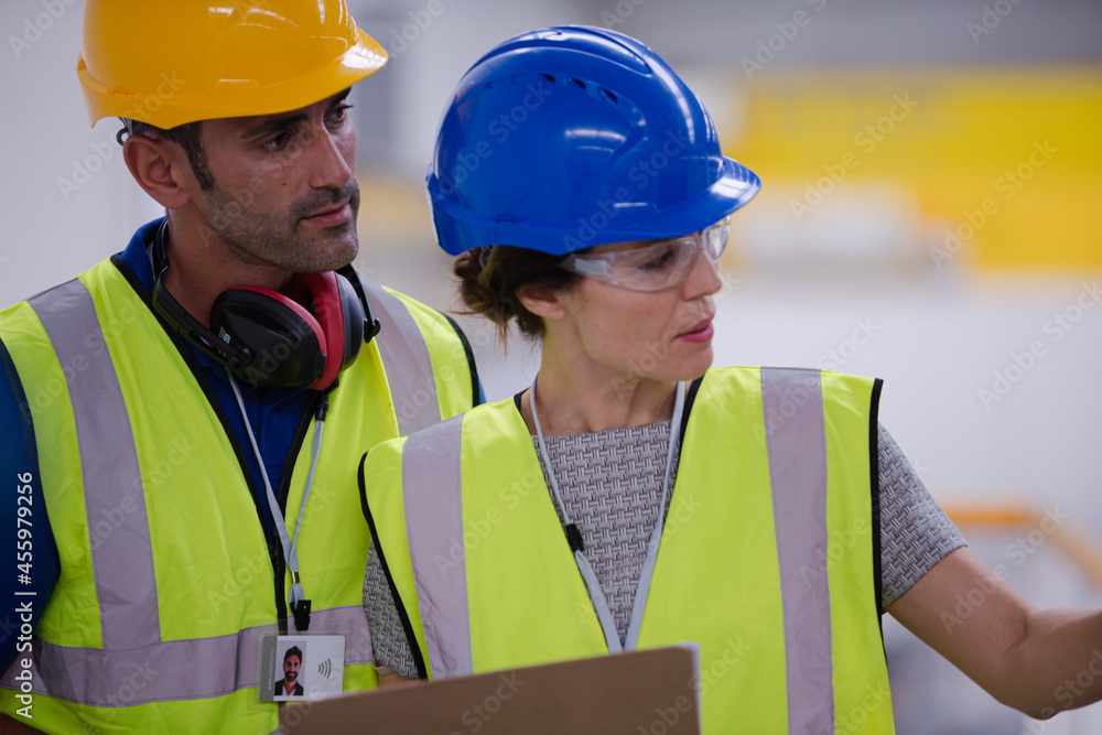 Supervisor and worker talking in factory Supervisor and worker talking in factory