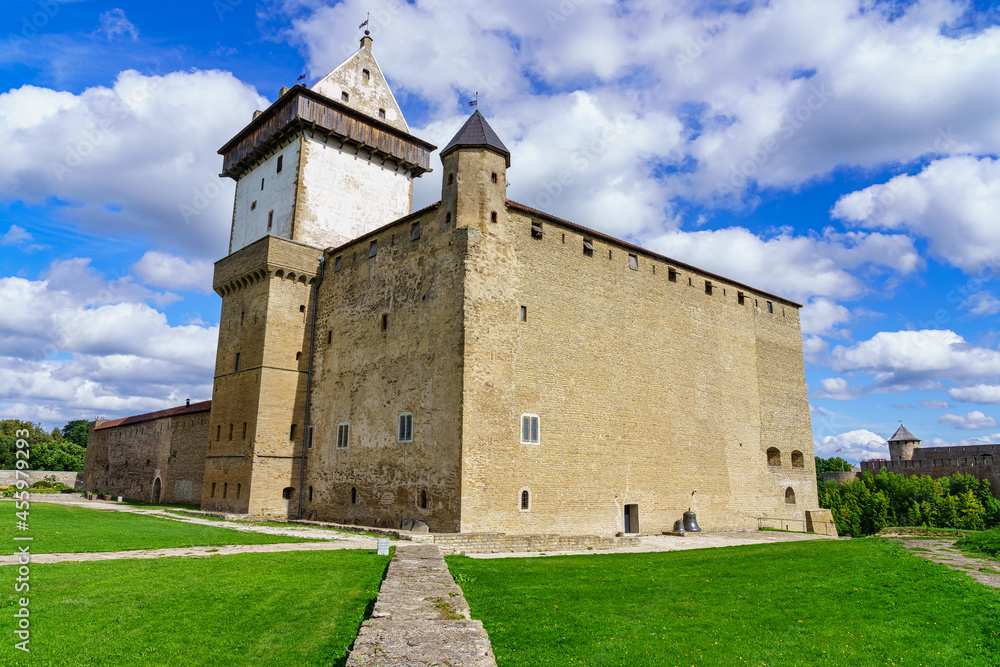 Majestic medieval castle in Narva Estonia on sunny day and sky with clouds.