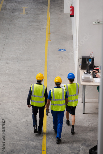Supervisor and workers walking in factory