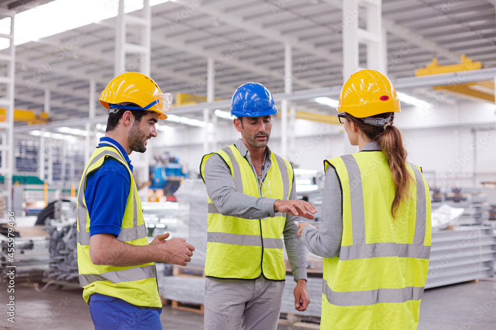 Supervisor and workers talking in steel factory Supervisor and workers talking in steel factory