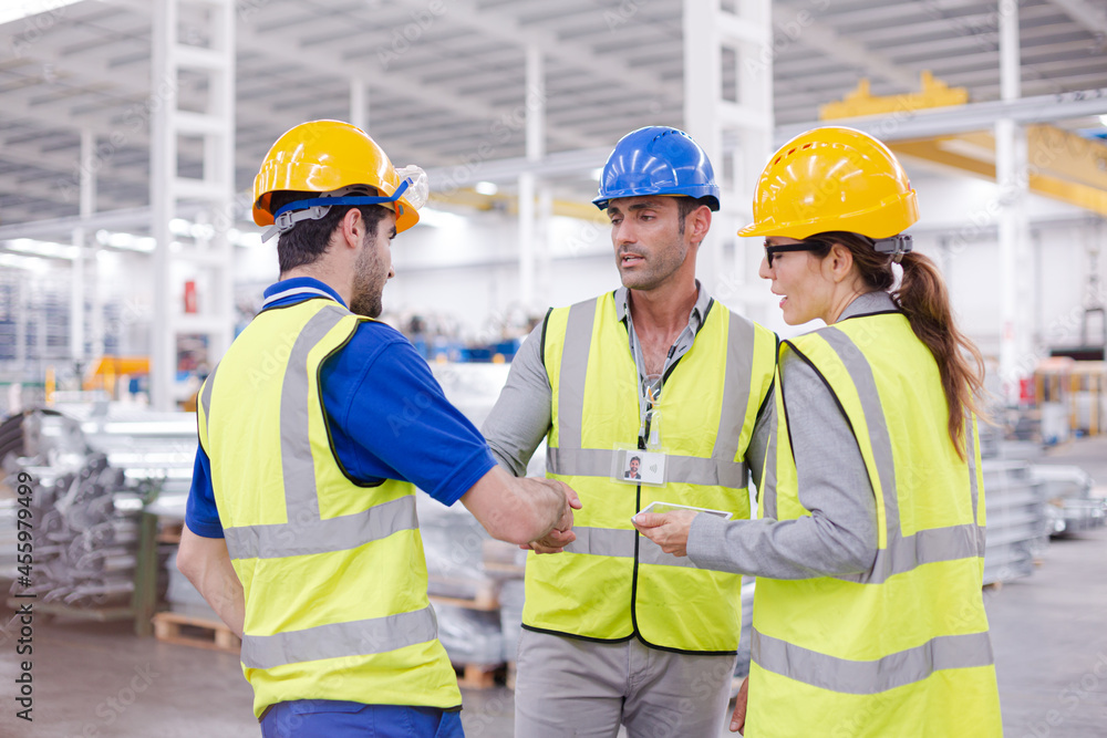 Supervisor and workers talking in steel factory Supervisor and workers talking in steel factory
