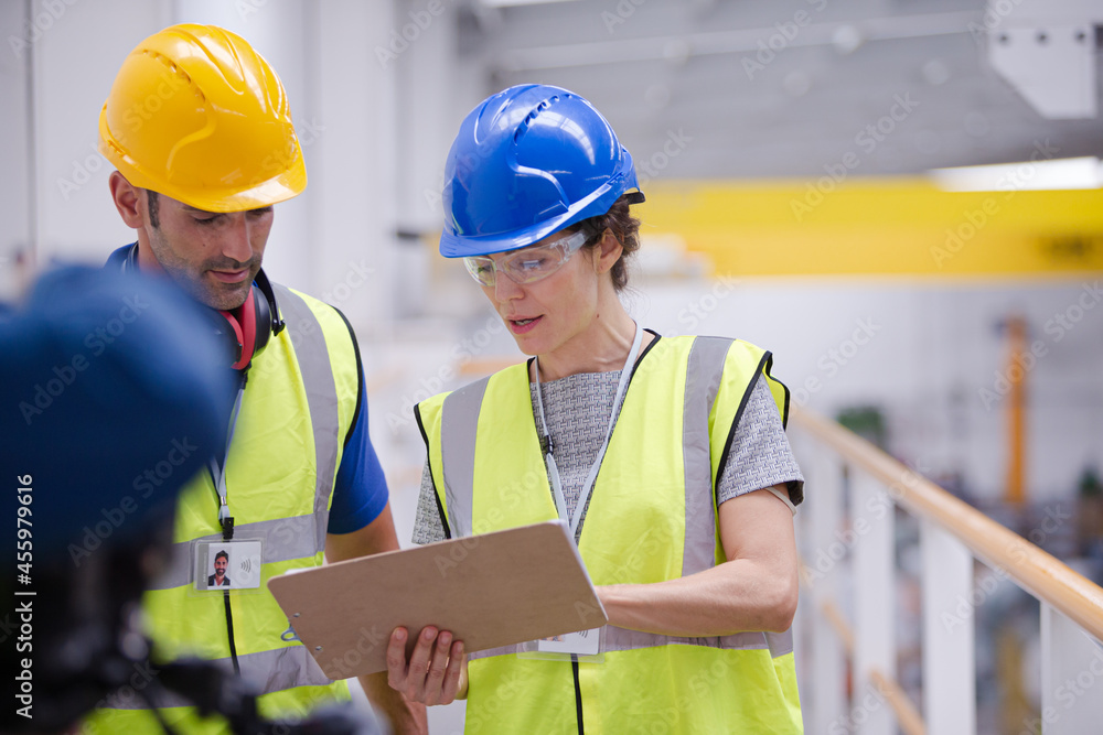 Supervisor and worker talking in factory Supervisor and worker talking in factory