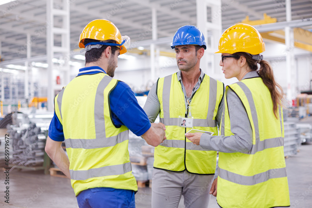 Supervisor and workers talking in steel factory Supervisor and workers talking in steel factory