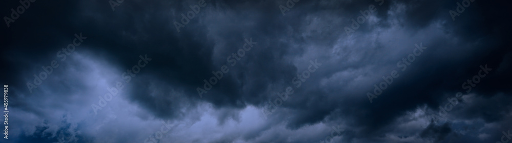 Heavy gray storm clouds. Gloomy sky background for design. Web banner. Website header. Heavy gray storm clouds. Gloomy sky background for design. Web banner. Website header.
