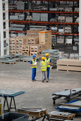 Workers and supervisor talking in factory