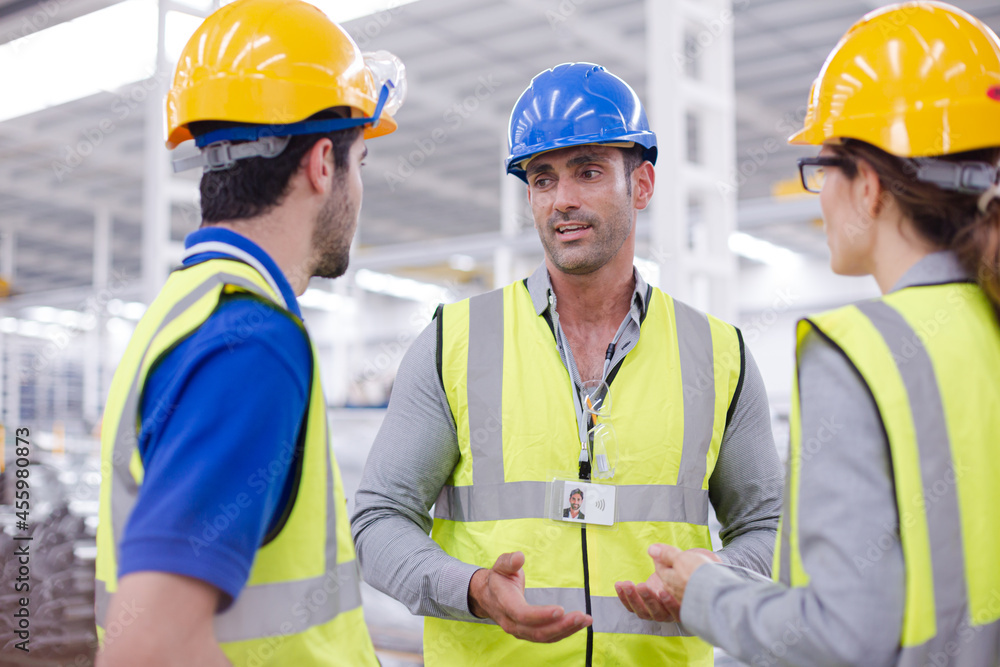 Supervisor and workers talking in steel factory Supervisor and workers talking in steel factory
