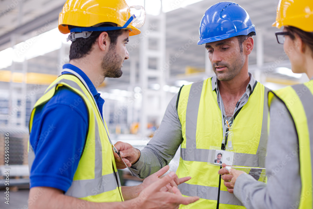 Supervisor and workers talking in steel factory Supervisor and workers talking in steel factory