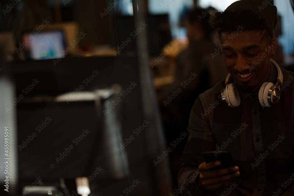 Young man working at computer in office Young man working at computer in office