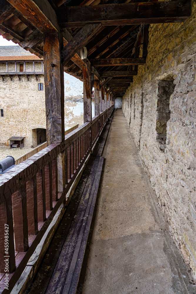 Medieval old balcony with railing and wooden ceiling in long perspective. Medieval old balcony with railing and wooden ceiling in long perspective.