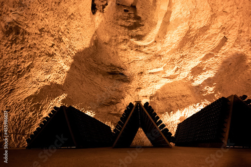 Deep and long undergrounds caves for making champagne sparkling wine from chardonnay and pinor noir grapes in Reims, Champagne, France photo