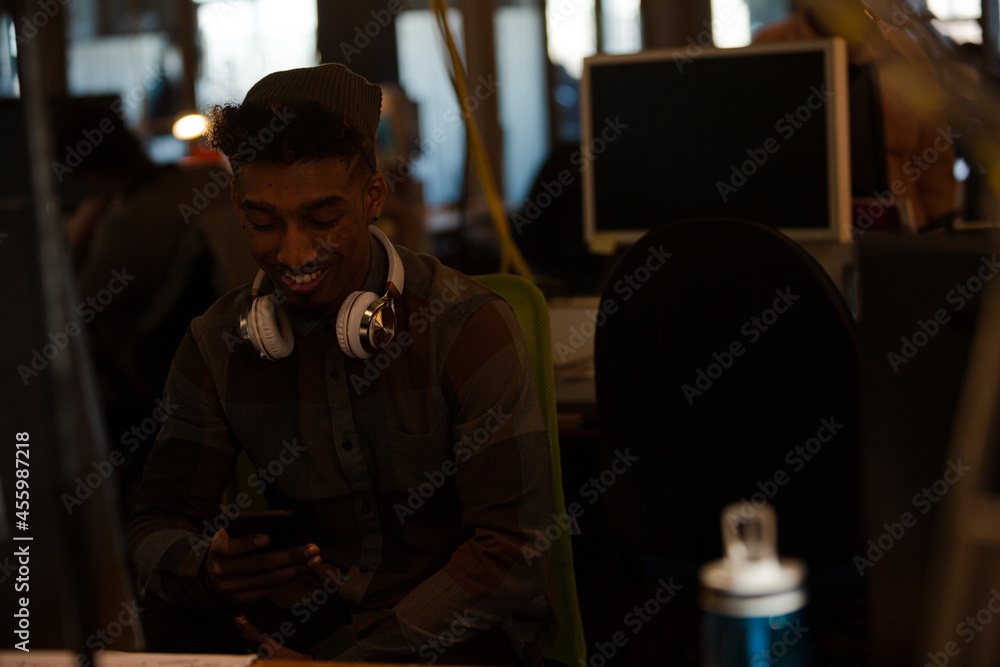 Young man working at computer in office Young man working at computer in office