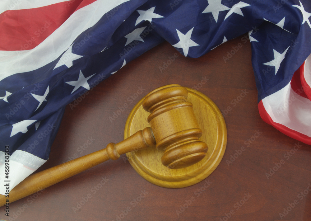 Wooden judge gavel with USA flag. Justice and laws in US concept.