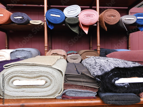 Multicolored fabric rolls liying in a counter