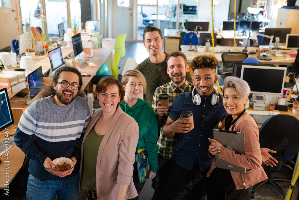 Team posing in office, smiling Team posing in office, smiling