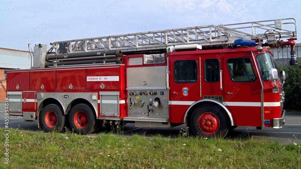Fire truck with retractable ladder for extinguishing fires at height. A ...