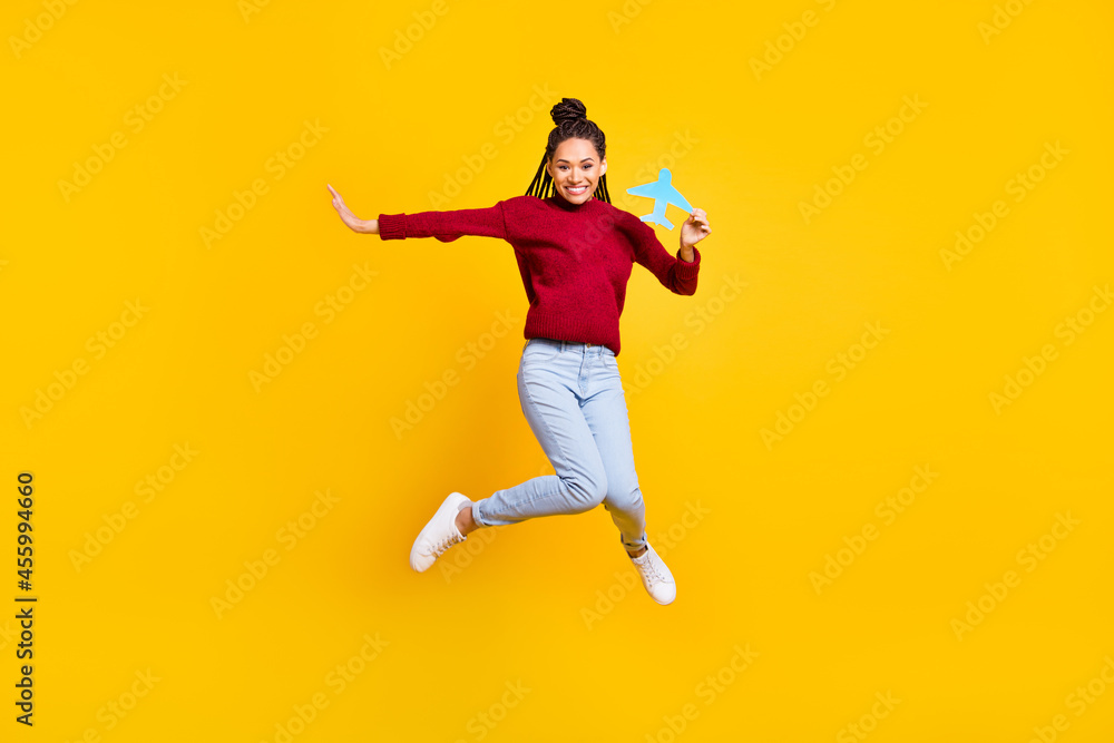 Full length body size photo woman keeping paper craft plane jumping isolated vibrant blue color background