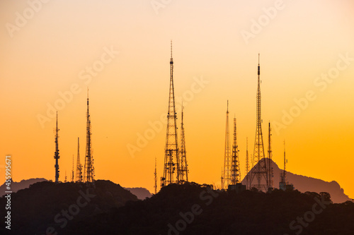 silhouette of communication antennas on the sumare hill in rio de janeiro, brazil.