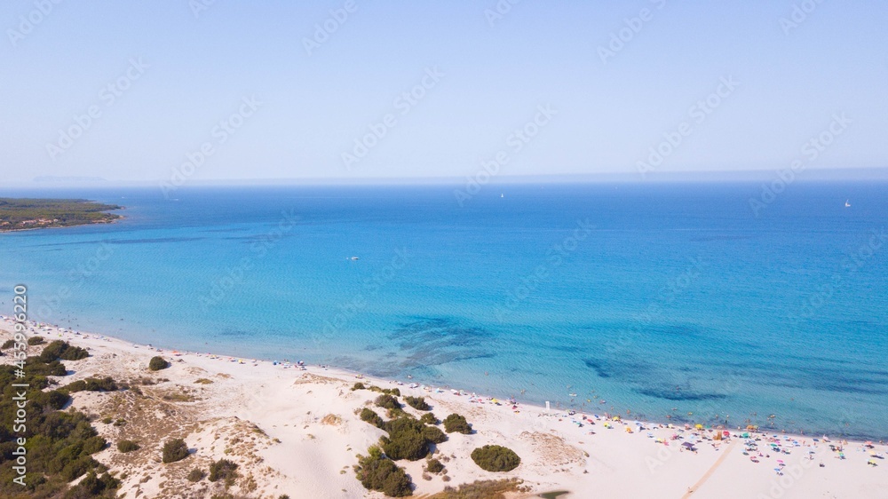 Aerial view of beautiful seascape with tourists at the coast of sand beach against clear sky. Summer seascape with tourists, beach horizon and clear sky