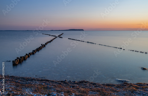 Fototapeta Naklejka Na Ścianę i Meble -  Cross groin with sunset in Dranske at the baltic sea, Rügen, longtime exposure
