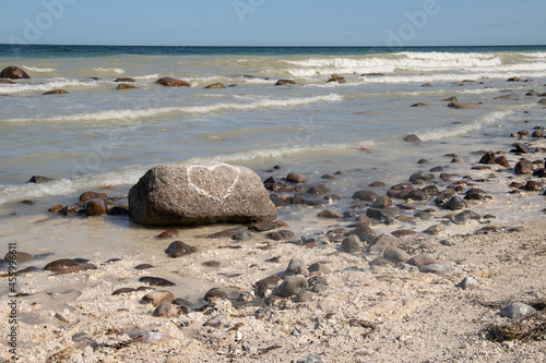 big stone with a white heart on baltic sea, rügen photo
