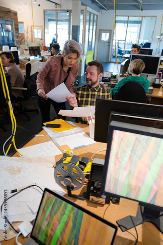 Wallpaper Mural Man and woman discussing paperwork at desk Torontodigital.ca