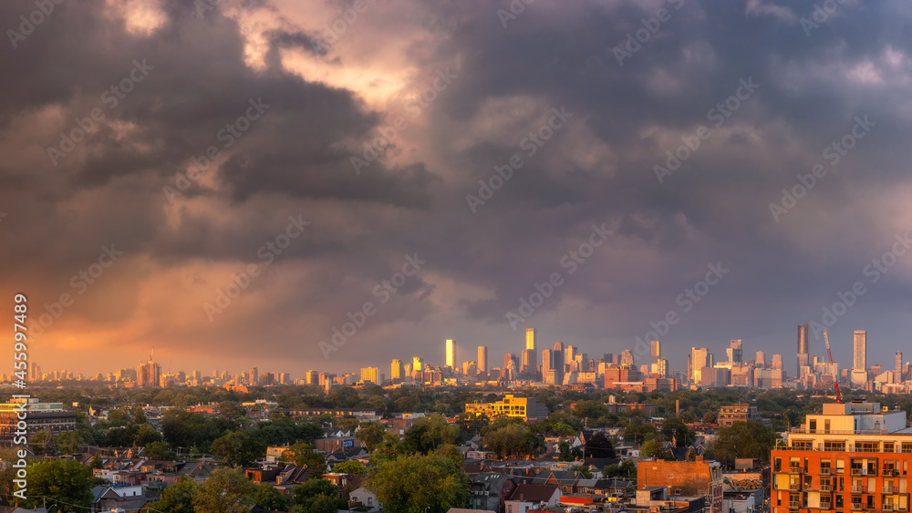 Colorful sunset illuminating storm clouds over the downtown Toronto skyline in Ontario Canada