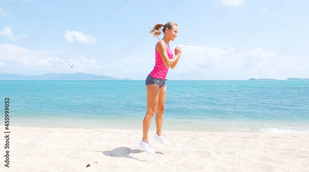 Fitness sport woman running on beach outside at sunset. Healthy lifestyle image of beautiful young asian woman jogging on black sand beach.