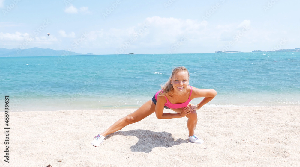 Fitness sport woman running on beach outside at sunset. Healthy lifestyle image of beautiful young asian woman jogging on black sand beach.