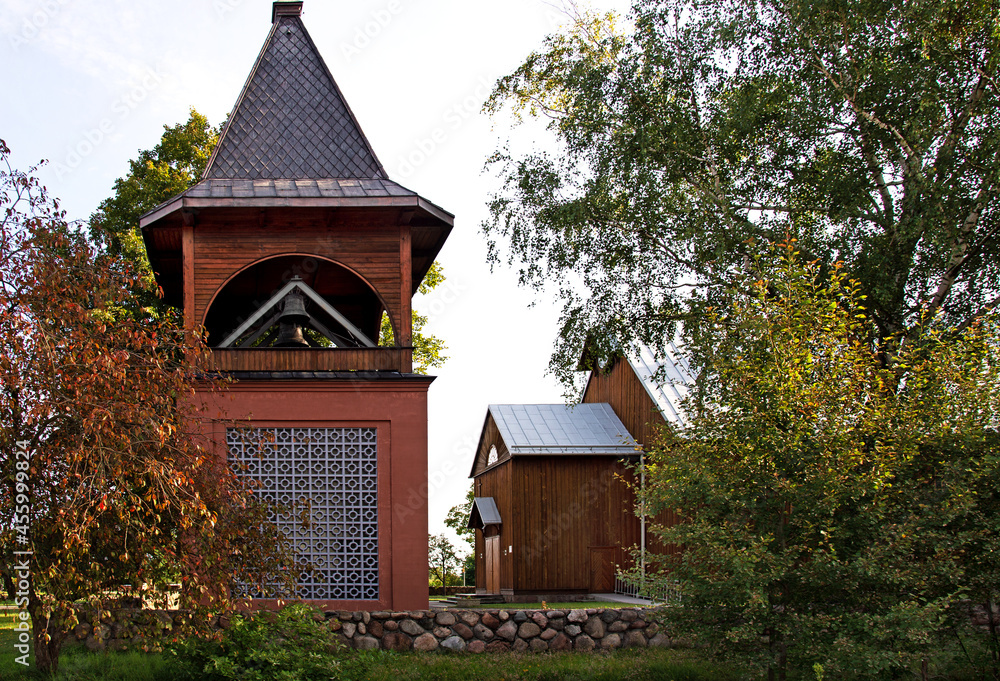 General view and architectural details of the belfry and the wooden Catholic church of St. Andrew Bobola built in 1938 in the village of Skierkowizna in Mazovia, Poland. General view and architectural details of the belfry and the wooden Catholic church of St. Andrew Bobola built in 1938 in the village of Skierkowizna in Mazovia, Poland.