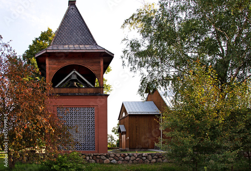 General view and architectural details of the belfry and the wooden Catholic church of St. Andrew Bobola built in 1938 in the village of Skierkowizna in Mazovia, Poland.