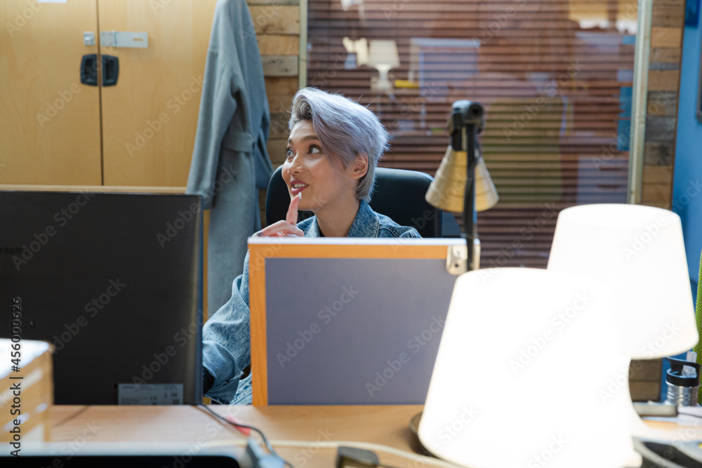 Young woman working at computer in office Young woman working at computer in office