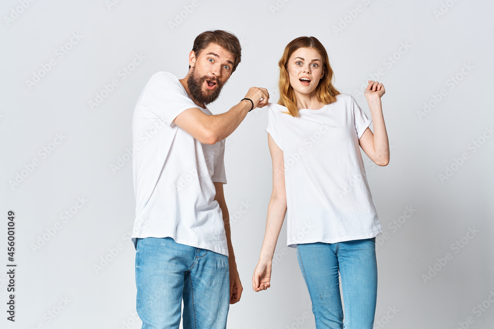 man and woman in white t-shirts studio fashion posing man and woman in white t-shirts studio fashion posing