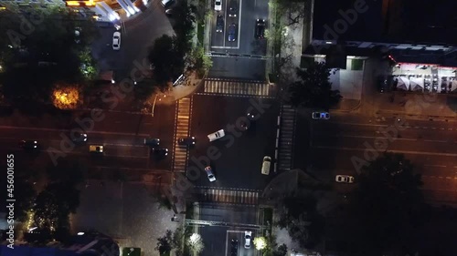 Night city. Big city lights. Shooting with the drone. The view from the top. Many cars go on the road. Lights and lanterns included. Lighted sidewalks and houses. Lights on the street. Above the house photo