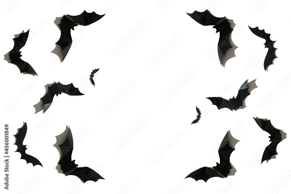 Black paper bat on a white background. Halloween concept. With a hard black shadow. Black paper bat on a white background. Halloween concept. With a hard black shadow.