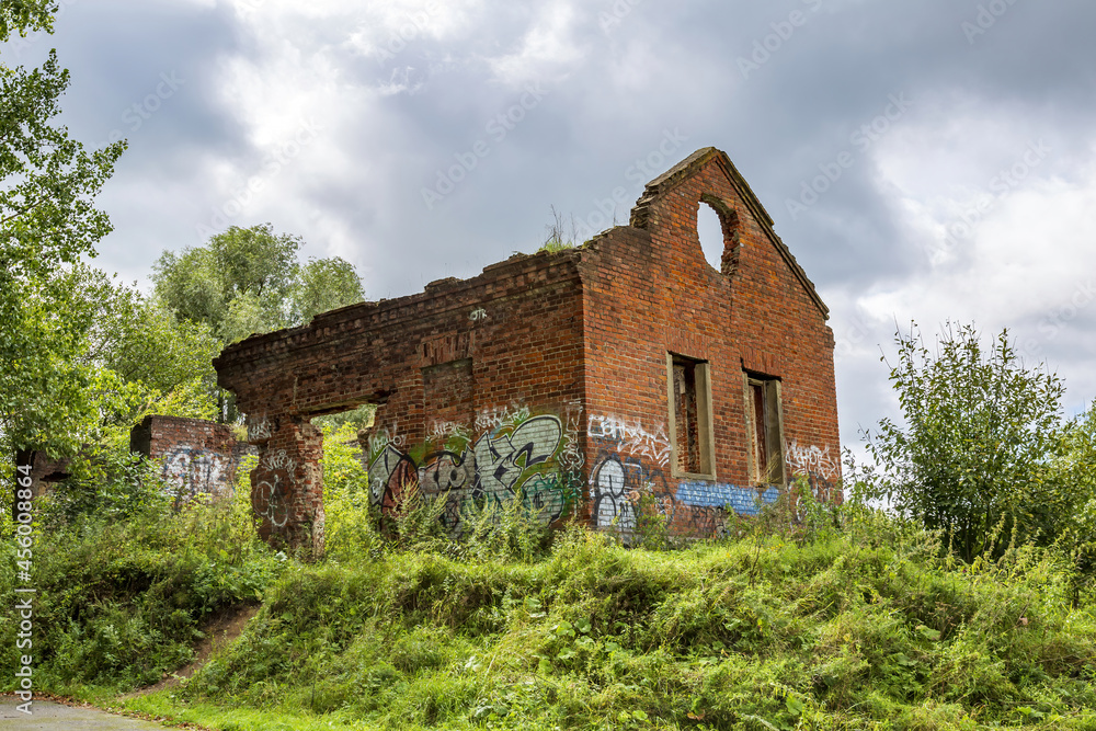 Ruined building of an old brick water pumping station in the Riviera city park. Built in 1870. Mozhaysk, Russia