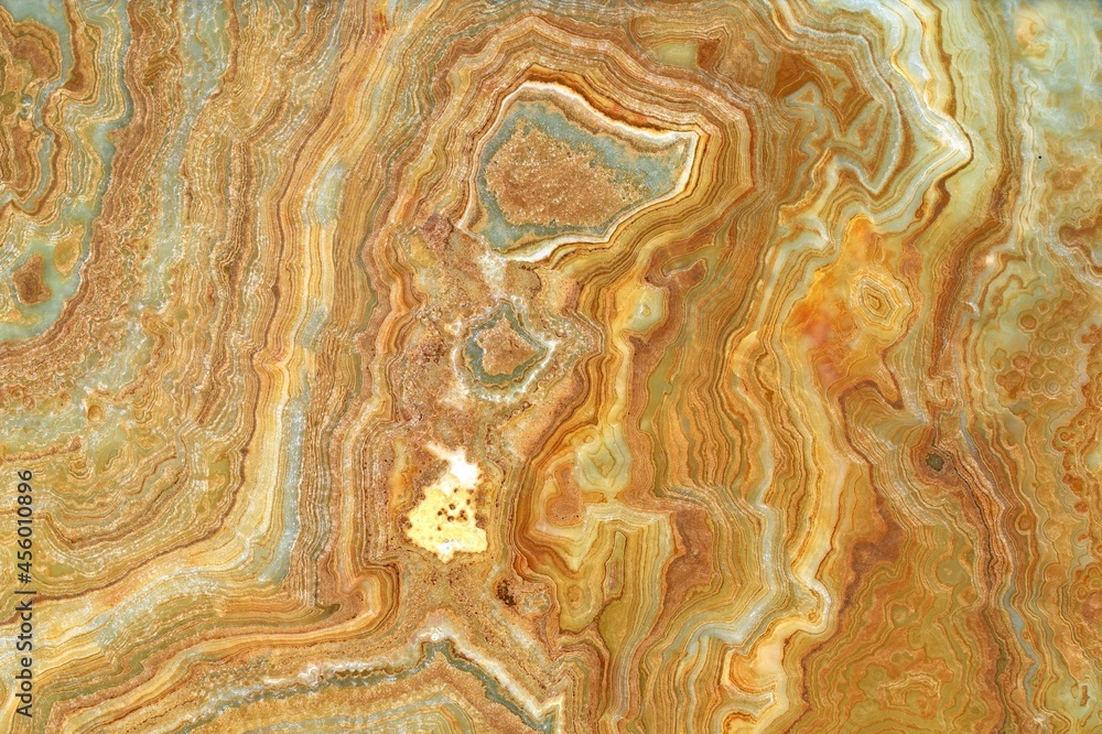 Onyx marble stone , crossed cut. Main colors are brown and green.Texture and background.