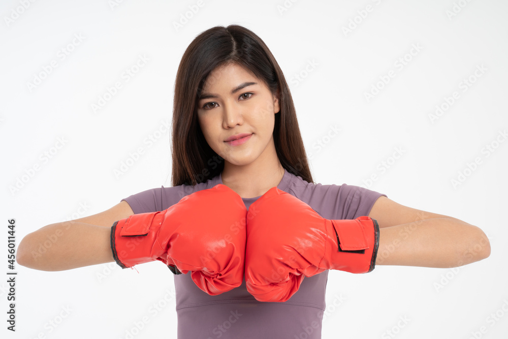 Portrait of beautiful Asian woman standing smile wearing the red boxing gloves, studio shot isolated on white background, Concept of fitness, exercise and healthy Portrait of beautiful Asian woman standing smile wearing the red boxing gloves, studio shot isolated on white background, Concept of fitness, exercise and healthy