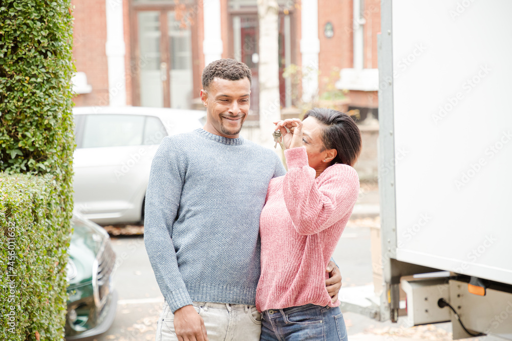 Portrait couple hugging outside new house Portrait couple hugging outside new house