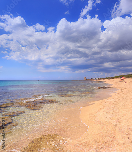 Torre Colimena Beach in Apulia, Italy: Punta Cacata. Inside the Nature Park “Palude del Conte e Dune Costiere”, the beach stretches in the area of Manduria. On background the watchtower of town.