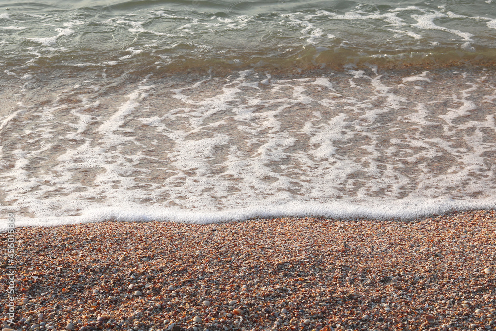 Beautiful seascape with waves and sea foam on shore Beautiful seascape with waves and sea foam on shore
