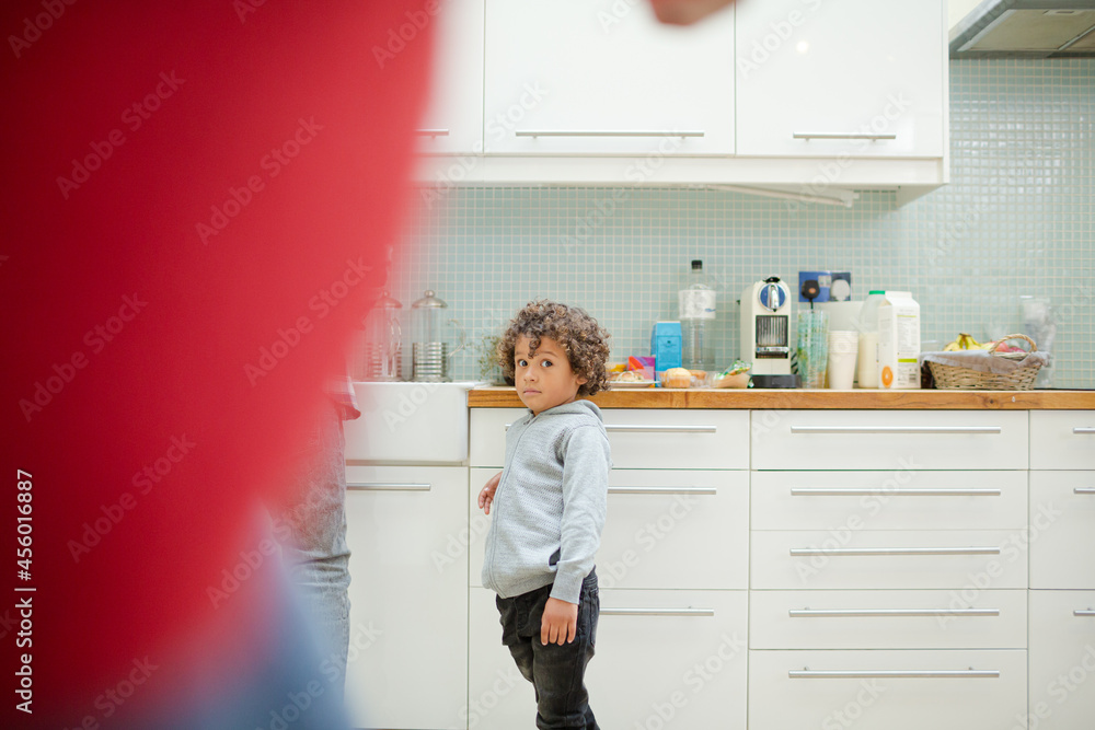Father and son standing in kitchen Father and son standing in kitchen